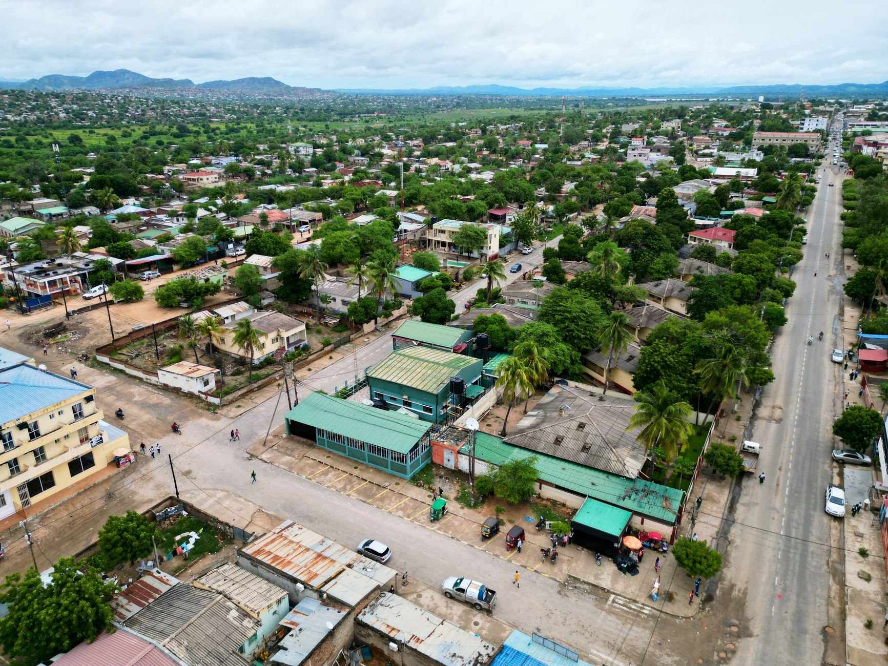 A vibrant aerial view of a city in Africa with lush greenery and urban structures.